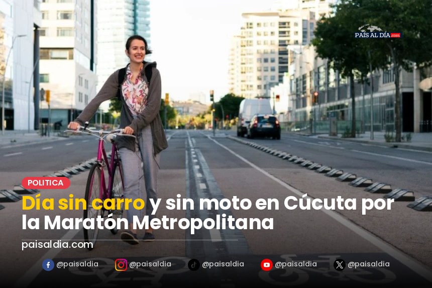 Corredores animados cruzan la línea de meta en la Maratón Metropolitana de Cúcuta, con banderas ondeando y público animando.