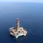 Equipos de perforación trabajan en el mar Caribe colombiano, con plataformas y barcos de apoyo en acción.