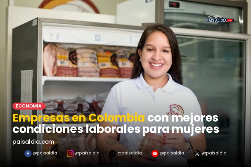 Mujeres en una reunión de trabajo, sonriendo y colaborando en un ambiente moderno y luminoso.