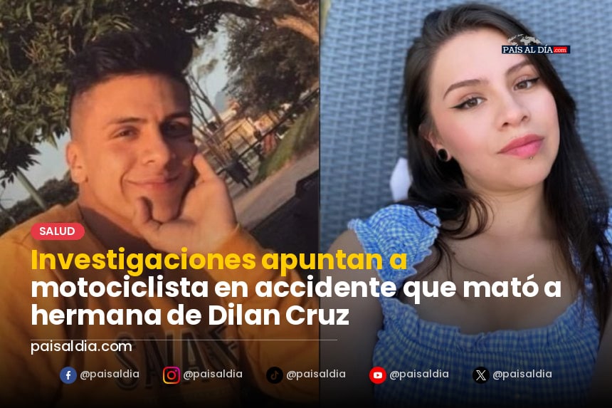 Motocicleta volcada en la calzada, rodeada de policías y curiosos en la escena del accidente.